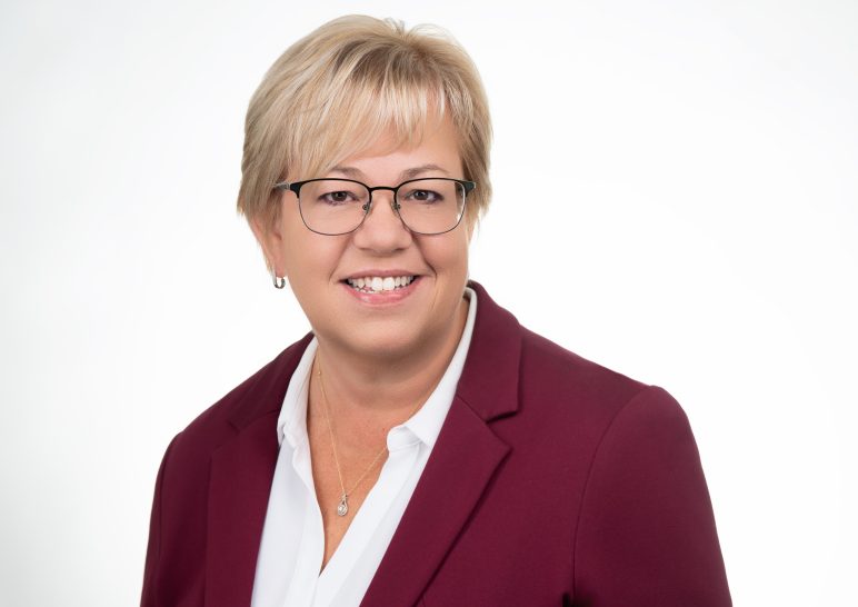 A studio portrait of a professional business headshot.