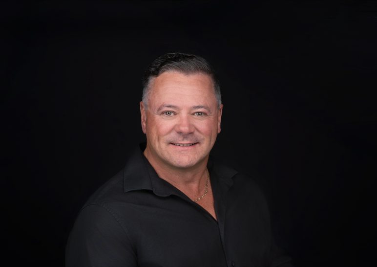 A studio portrait of a professional business headshot.