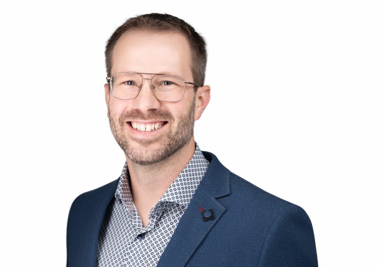 A studio portrait of a professional business headshot.