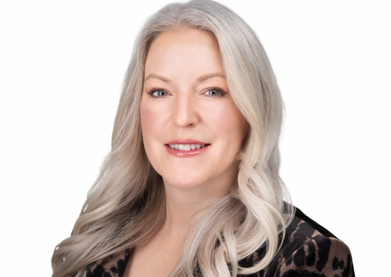 A studio portrait of a professional business headshot.