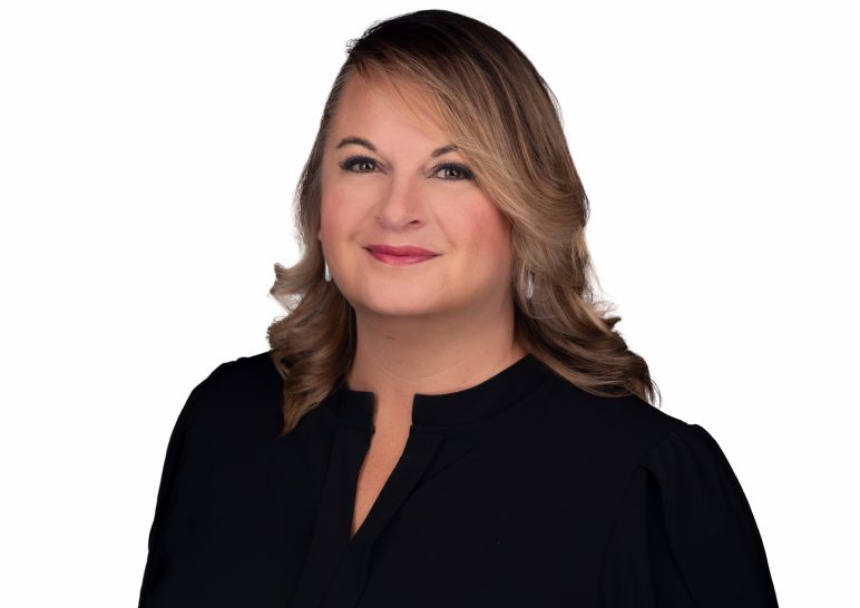 A studio portrait of a professional business headshot.