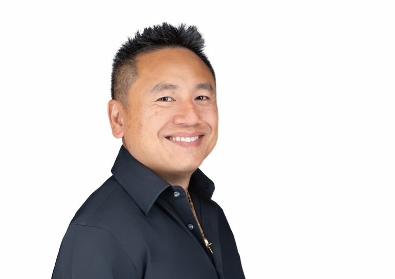 A studio portrait of a professional business headshot.